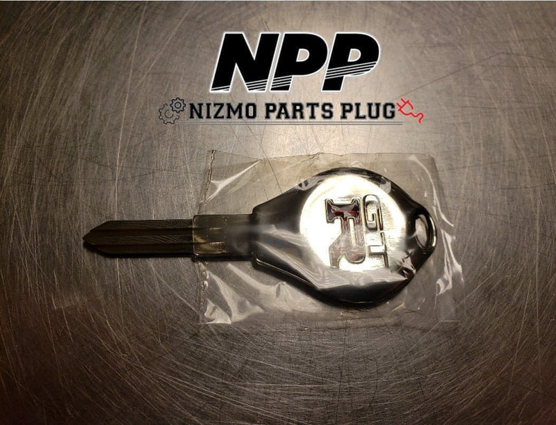 Load image into Gallery viewer, New OEM silver Skyline GT-R master key blank for R32/R33 models, sealed in original plastic packaging.