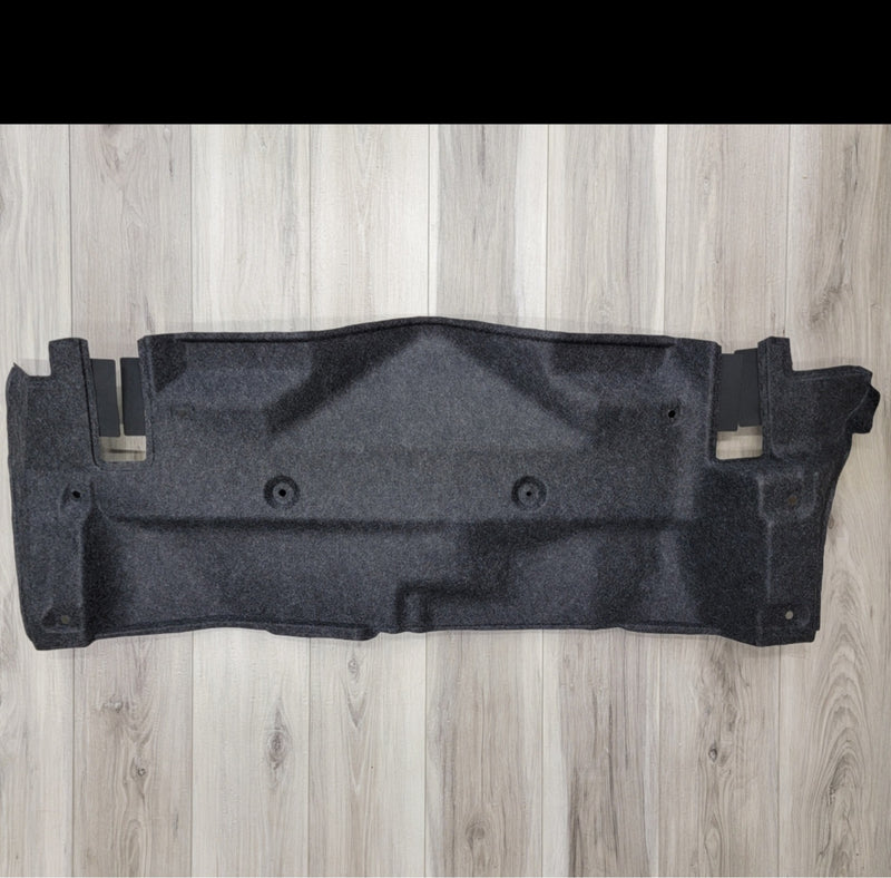 Load image into Gallery viewer, Grey R34 Skyline GTR trunk battery finisher panel in clean, pre-owned condition on a light wood floor.
