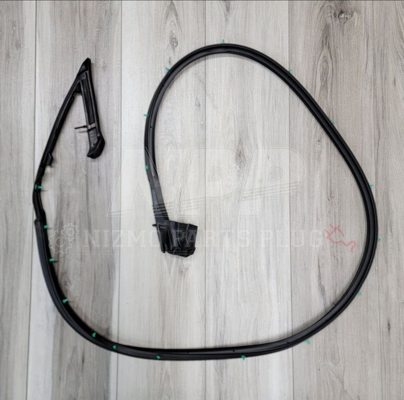Load image into Gallery viewer, Black lower weatherstripping molding set for S13 180SX/240SX with green installation clips on wood background.