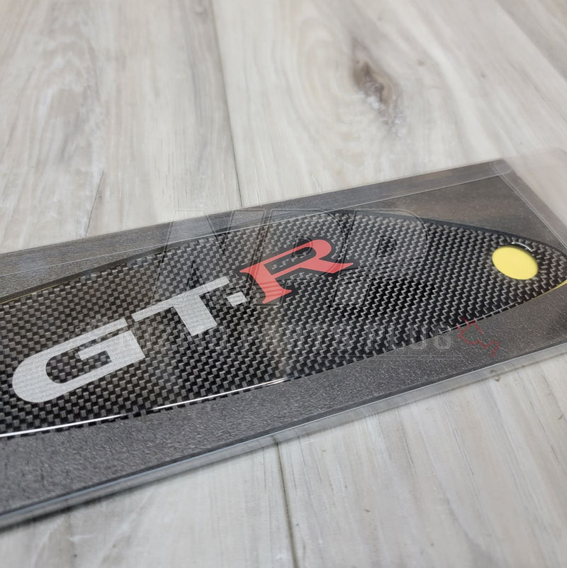 Load image into Gallery viewer, New carbon fiber spoiler cover for Nissan R33 Skyline GTR, featuring silver and red GT-R lettering in clear packaging.