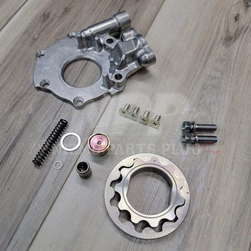 Load image into Gallery viewer, New engine oil pump kit for Nissan S13 240SX KA24DE. Includes silver housing, inner gear, bolts, and spring hardware.