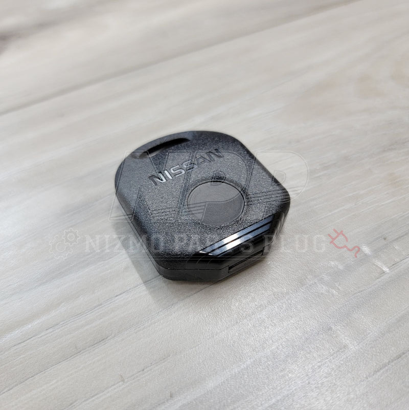 Load image into Gallery viewer, Black Nissan keyless entry remote for R33, 180SX, and S14 on a light wood grain surface.