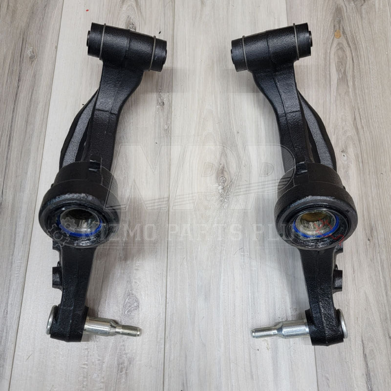 Load image into Gallery viewer, Black R33/R34 GTR front extension knuckle arm set in excellent condition, displayed on a light wood background.