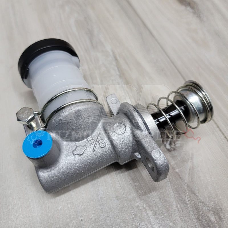 Load image into Gallery viewer, New Nissan R32/R33/R34 Skyline GTR clutch master cylinder, silver metal body with a white reservoir and blue plug.