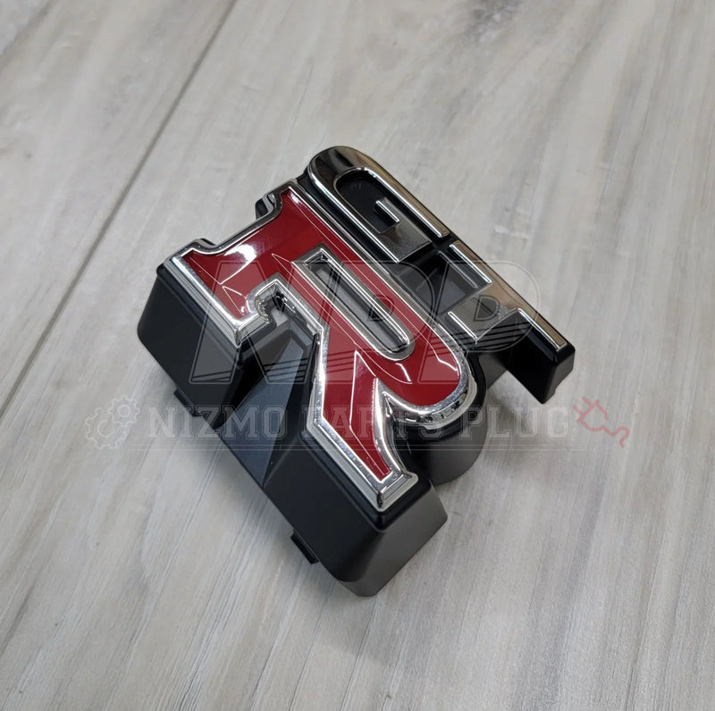 Load image into Gallery viewer, Nissan R33 Skyline GTR Front Upper Grill Emblem - NizmoPartsPlug
