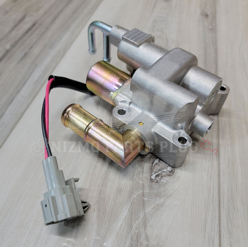 Load image into Gallery viewer, Nissan R34 Skyline GTT IACV with gold-tone metal fittings and gray wiring harness, in excellent clean condition.