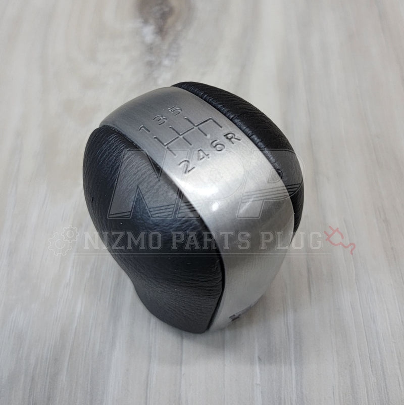 Load image into Gallery viewer, Nissan R34 Skyline GT-R Series 2 6-speed leather shift knob with a brushed metal top insert.