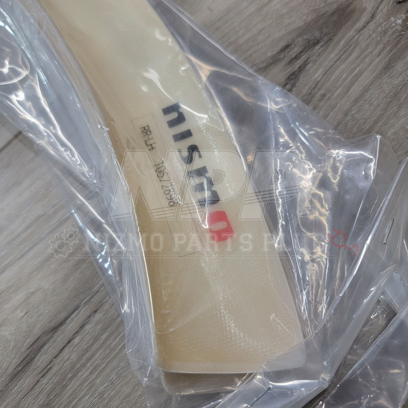 Load image into Gallery viewer, New Nissan BNR34 GTR Nismo fender flare extension in original plastic packaging, cream-colored finish.