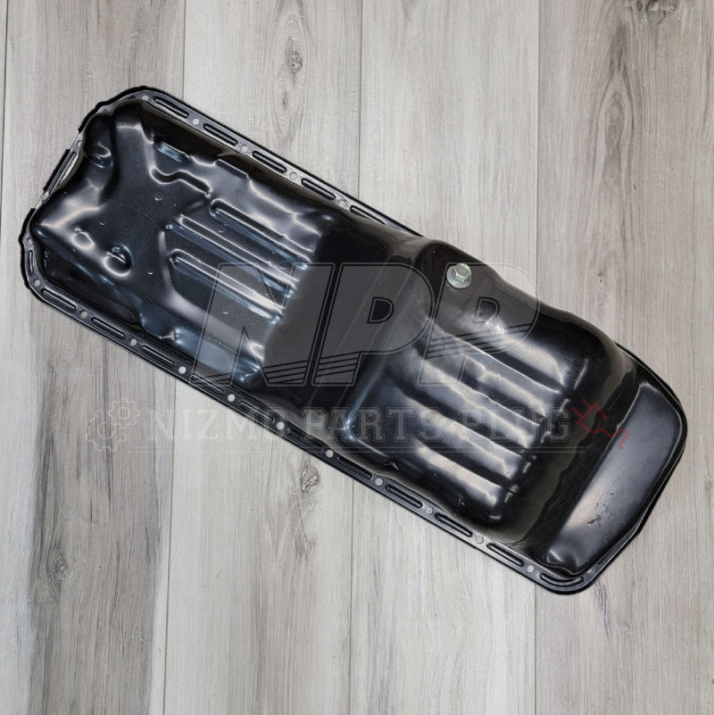 Load image into Gallery viewer, Glossy black RWD oil pan assembly for Nissan Skyline RB20/RB25DET engines, new condition, angled view.