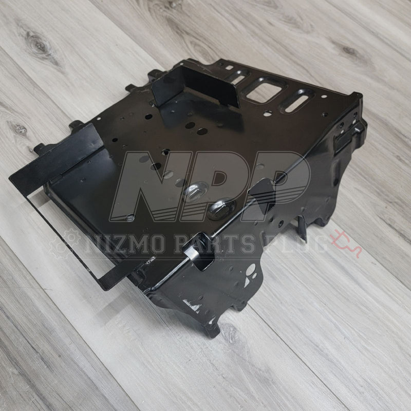 Load image into Gallery viewer, Black Nissan R34 Skyline GTR cold weather battery bracket assembly. High-quality metal part on a wooden surface.