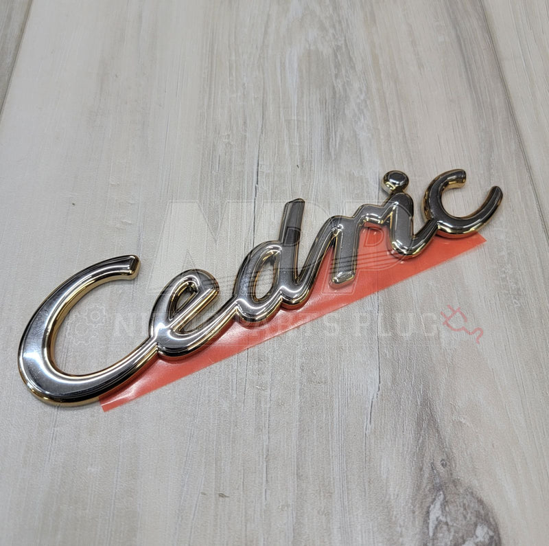 Load image into Gallery viewer, Nissan Y31 Cedric Script Front Emblem - NizmoPartsPlug