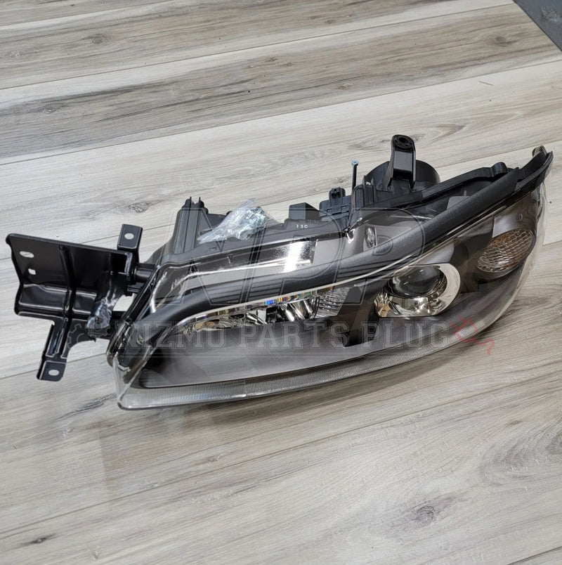 Load image into Gallery viewer, Nissan S15 Silvia HID LH Projector Headlight Assembly on a wooden background.