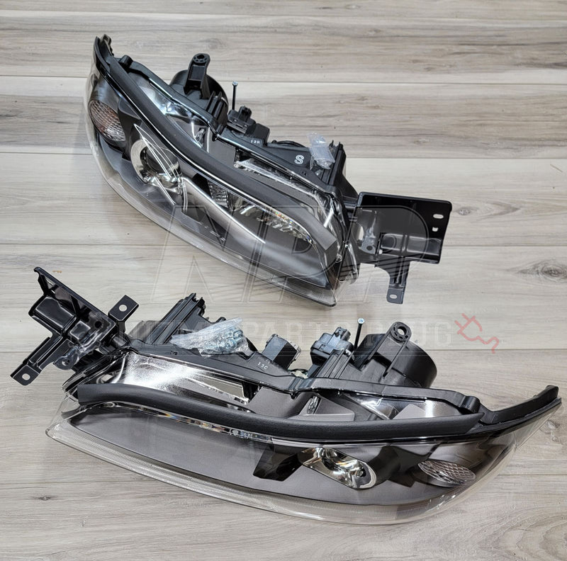 Load image into Gallery viewer, Complete OEM HID headlight set for Nissan S15 Silvia, featuring black inner housings and clear lenses.