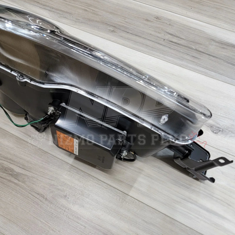 Load image into Gallery viewer, Nissan S15 Silvia HID LH Projector Headlight Assembly installed on a wooden surface from an OEM parts perspective.