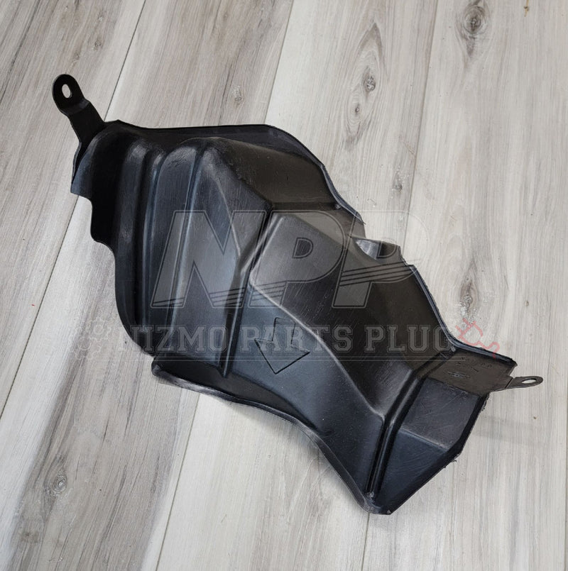 Load image into Gallery viewer, Black plastic fuel filler neck protector for Nissan R34 Skyline, shown on a light wood background.