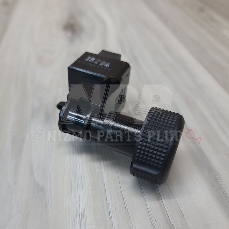 Load image into Gallery viewer, Black Nissan R32 Skyline headlight position switch assembly with a textured dial, in good condition.