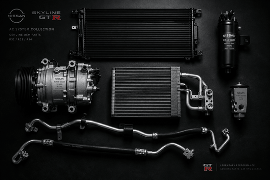 Nissan Skyline air conditioning parts laid out on a black floor.