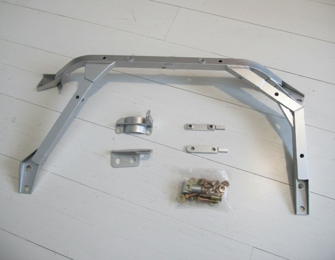 Nismo BNR34 GTR Front Floor Reinforcement Bar Assembly with mounting hardware and bolts on a white background.