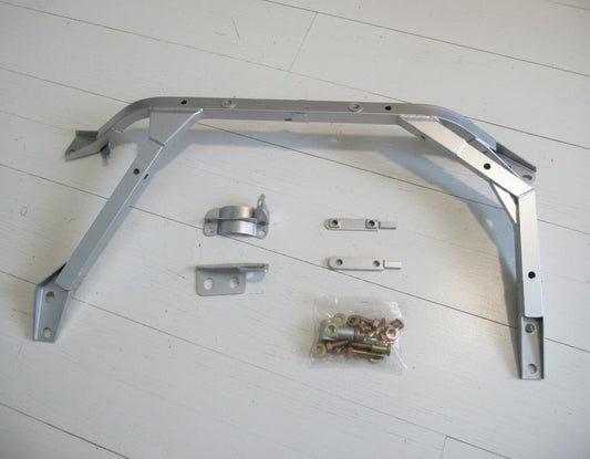 Nismo BNR34 GTR Front Floor Reinforcement Bar Assembly with mounting hardware and bolts on a white background.