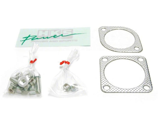 HKS Hi-Power exhaust hardware and gaskets for S14 240SX Silvia, including silver metal gaskets and bags of bolts.