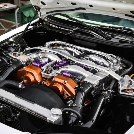 ZSPEC stainless fastener kit installed on a Nissan 300ZX Z32 engine featuring bronze and purple accents.