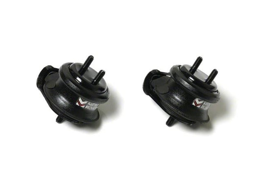 Two black Megan Racing hardened engine mounts for Nissan Skyline R33 and R34 on a white background.