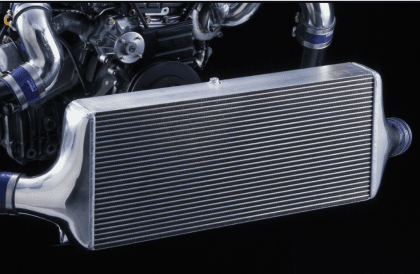HKS R Type Intercooler, Factory Replacement mounted in a turbocharged vehicle engine bay.