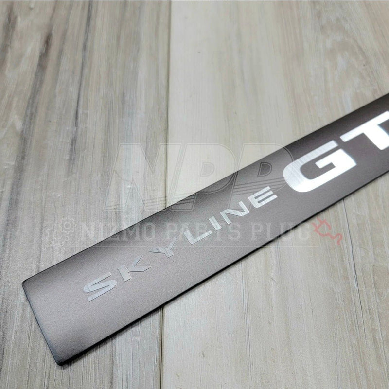 Load image into Gallery viewer, Nissan R34 Skyline GTR NÜR Center Valley Cover Emblem (RARE)
