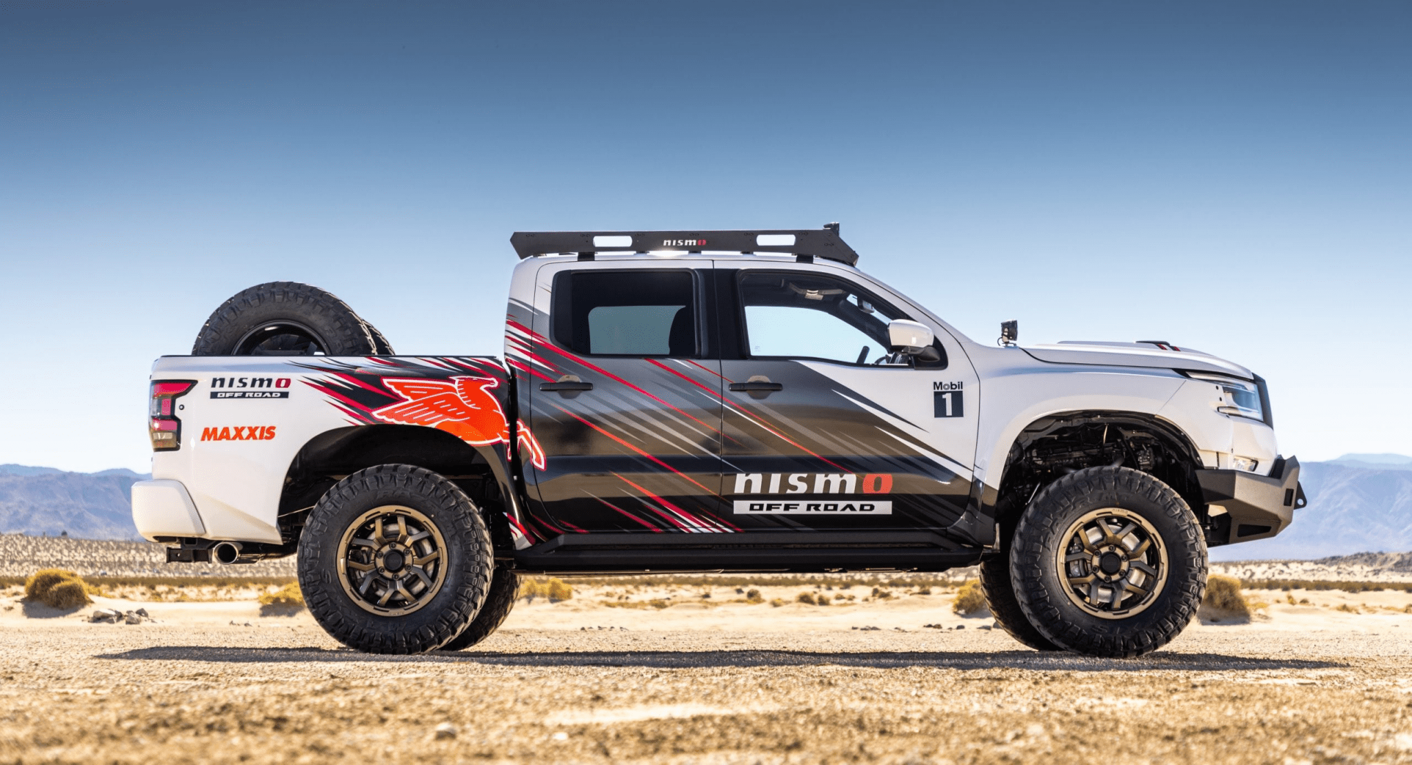 Customized pickup truck with Nismo branding on a desert road