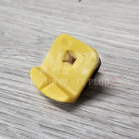 Yellow plastic component on a gray textured surface with 'Hizmo Parts Plug' branding.