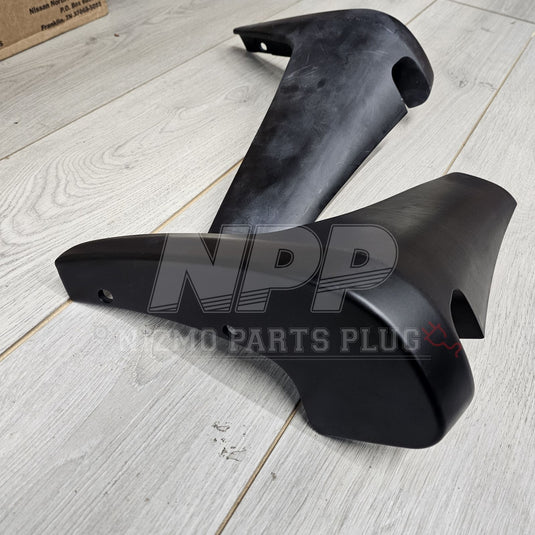Black N1 style rear mud guards for Nissan Skyline BNR32, shown in good, clean condition on a light wood floor.