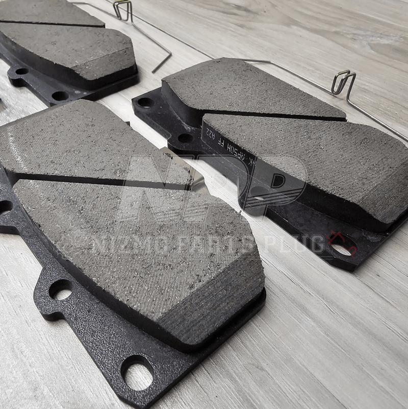 Load image into Gallery viewer, Brake pads on a wooden surface with a brand logo.
