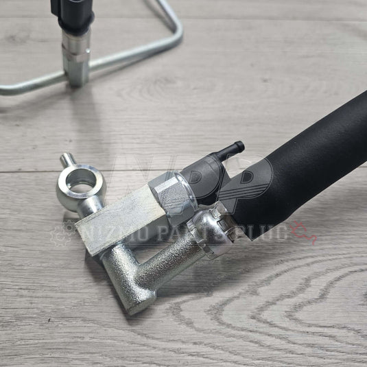 New black rubber and silver metal high-pressure power steering hose for Nissan R34 Skyline GT/GTT.