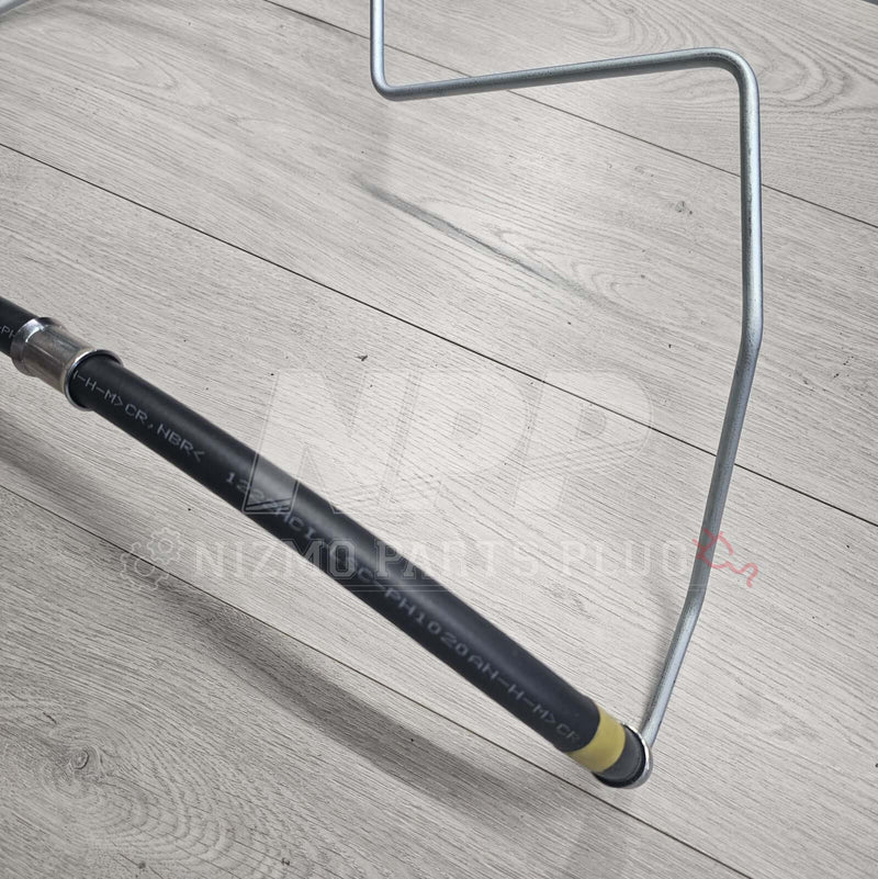 Load image into Gallery viewer, Nissan R34 Skyline high-pressure power steering hose and metal tube assembly, black rubber and silver metal finish.
