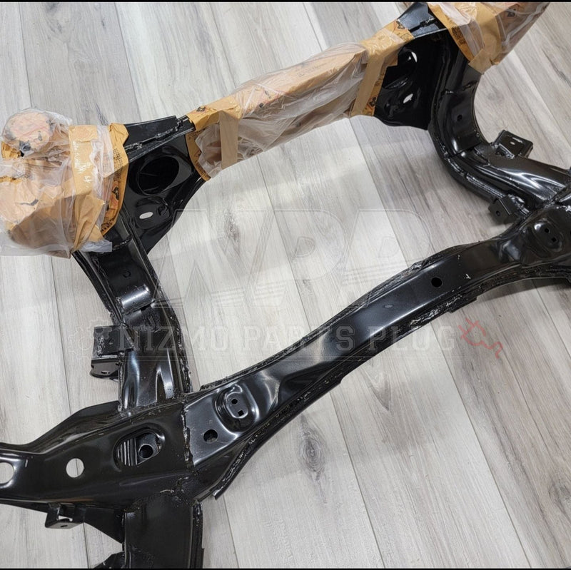 Load image into Gallery viewer, Black Nissan R34 Skyline GTR rear subframe assembly, restored and partially wrapped in protective plastic.
