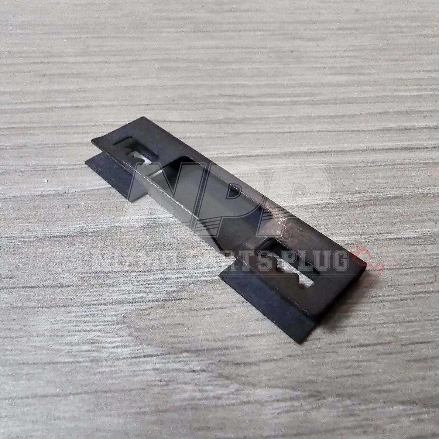 Nissan R32 Skyline GT-R Front Bumper Lower Grill Mounting Pressure Clip on a wooden surface.