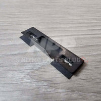 Nissan R32 Skyline GT-R Front Bumper Lower Grill Mounting Pressure Clip on a wooden surface.