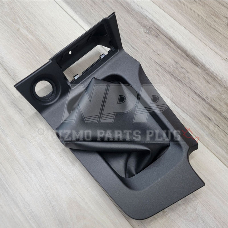Load image into Gallery viewer, Black car interior part on a light wooden surface with 'Mazda' branding.

