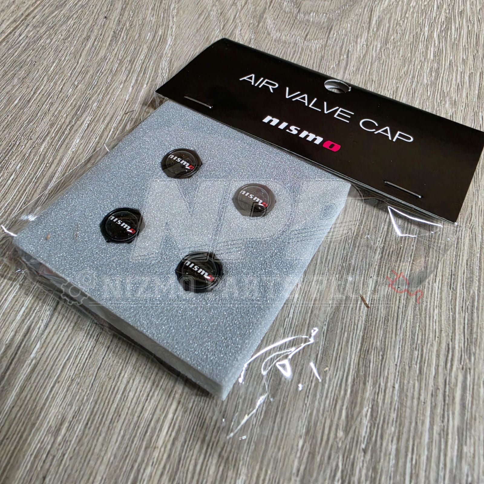 New Nissan Nismo aluminum tire valve stem cap set, black finish, universal fit for all Nissan models.