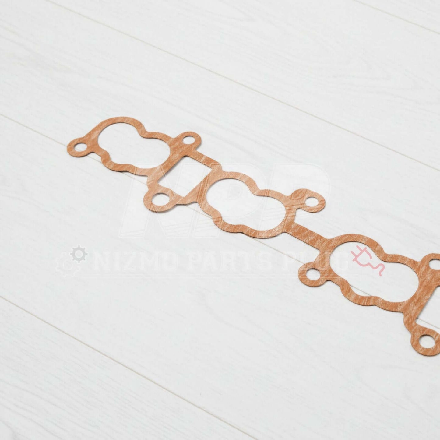 Nissan Skyline GTR RB26DETT Intake Manifold To Cylinder Head Gasket on a white wooden background