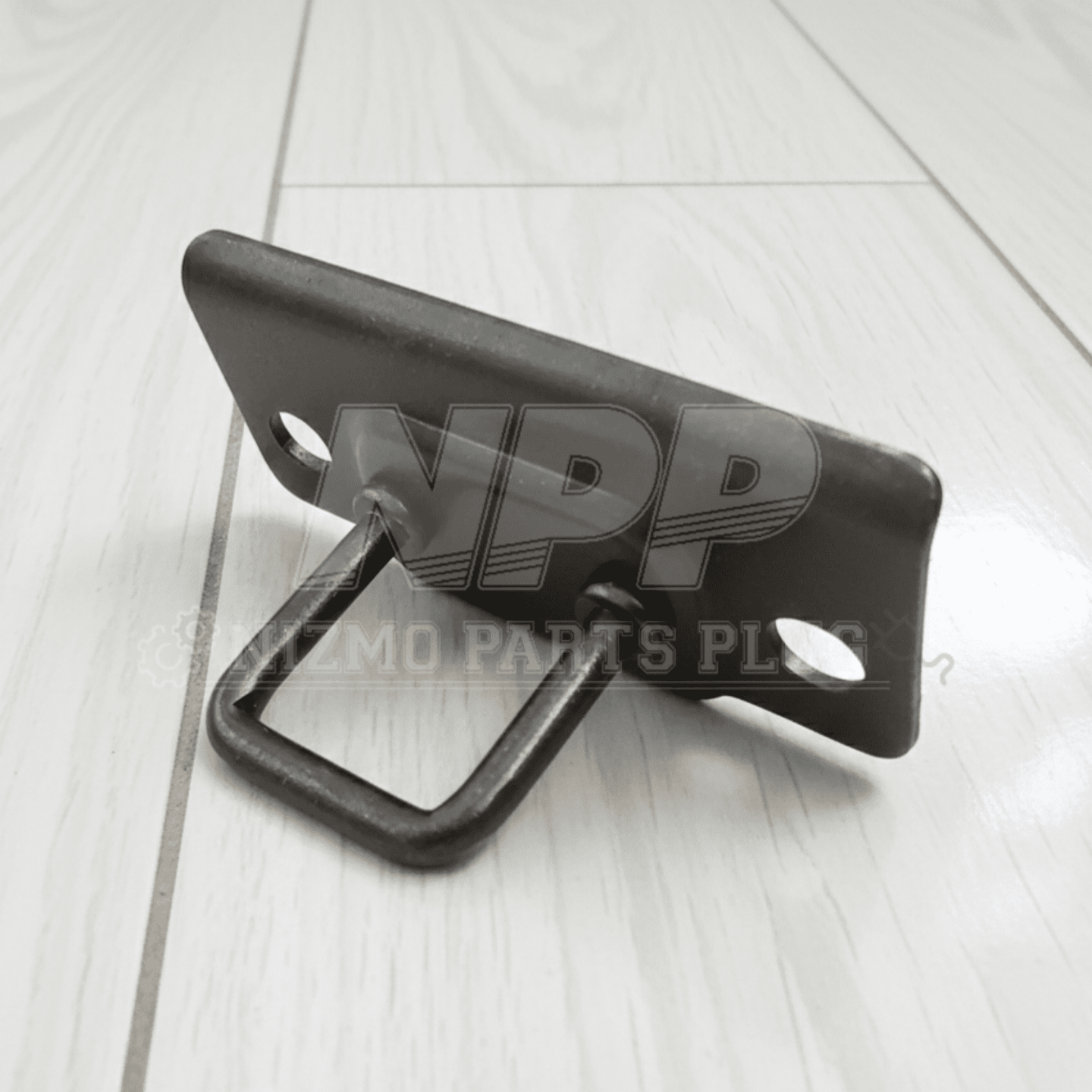 Black metal bracket on a light wooden surface with 'NPP Auto Parts' branding.