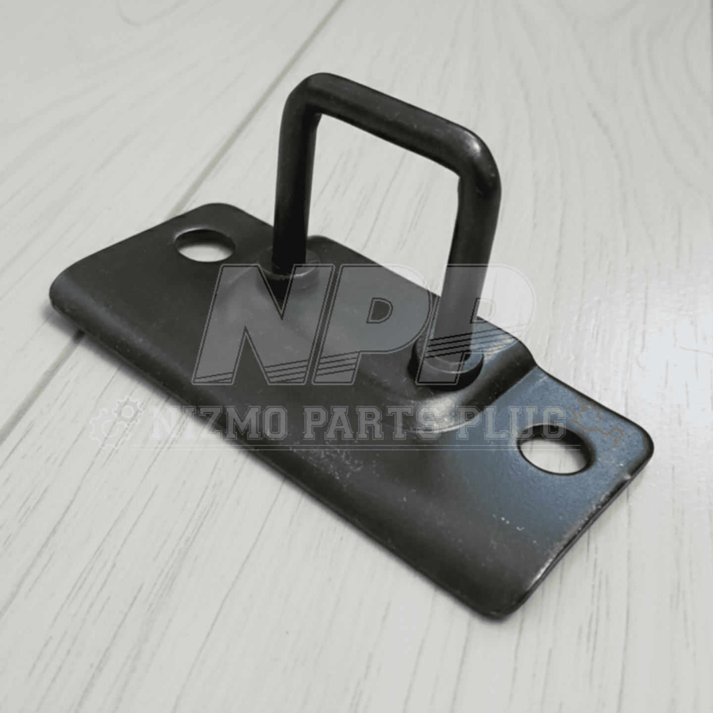 Black metal bracket with handle on a light wooden surface, branded 'NPP'.