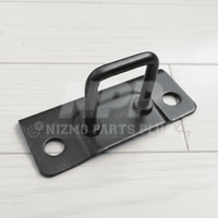 Black metal plate with handle on a white wooden surface, branded 'Nizmo Parts'.