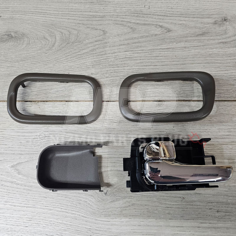 Load image into Gallery viewer, Nissan S15 Silvia interior door handles with chrome levers and grey plastic trim bezels on a light wood background.
