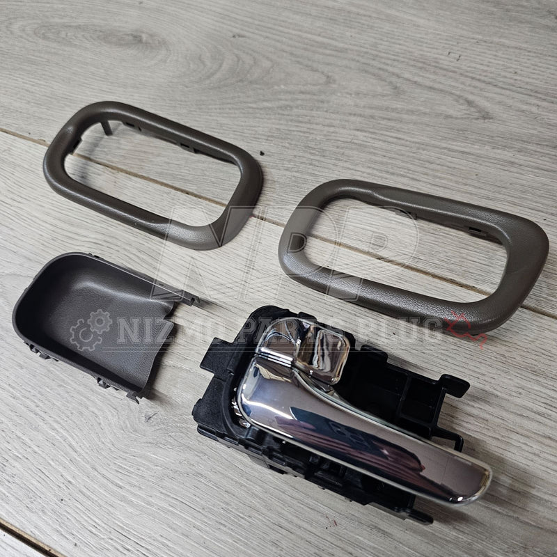 Load image into Gallery viewer, Nissan S15 Silvia chrome interior door handle set with grey plastic bezels on a wood-grain surface.
