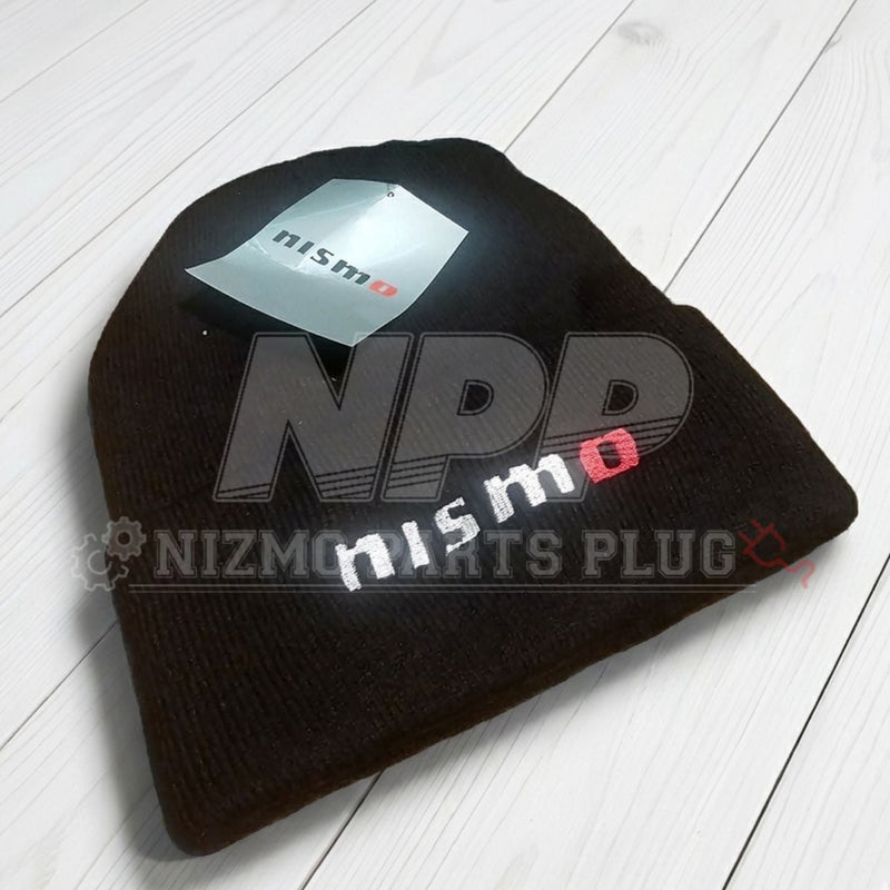 Load image into Gallery viewer, Black beanie with 'Nismo' branding on a light wooden surface
