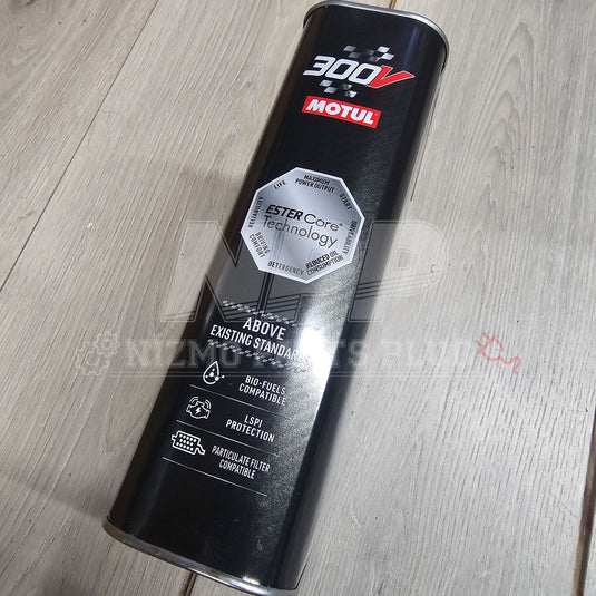 Motul 300V oil can on a wooden surface