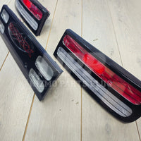 Nissan 300ZX rear tail lights and center panel on light wood floor