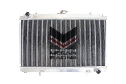 New 3-row aluminum Megan Racing radiator for Nissan 240SX S14, featuring silver finish and central brand logo.