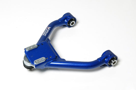 Blue Megan Racing front upper camber kit for Nissan Skyline R35, featuring metallic finish and mounting bushings.